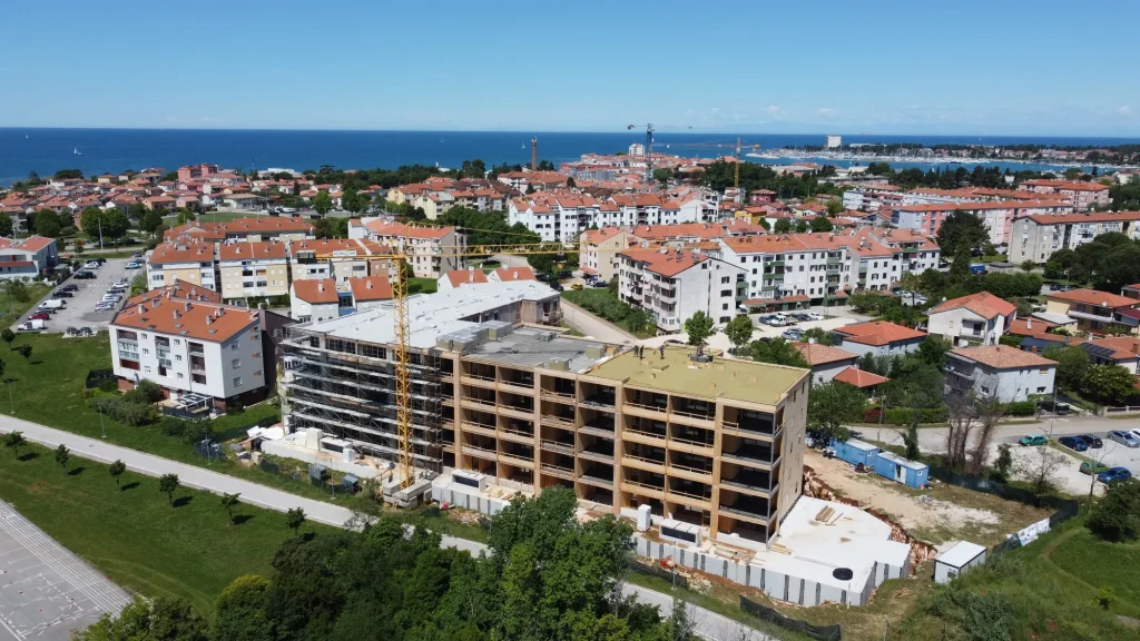 Zračni posnetek večstanovanjske lesene stavbe v gradnji sredi urbanega naselja